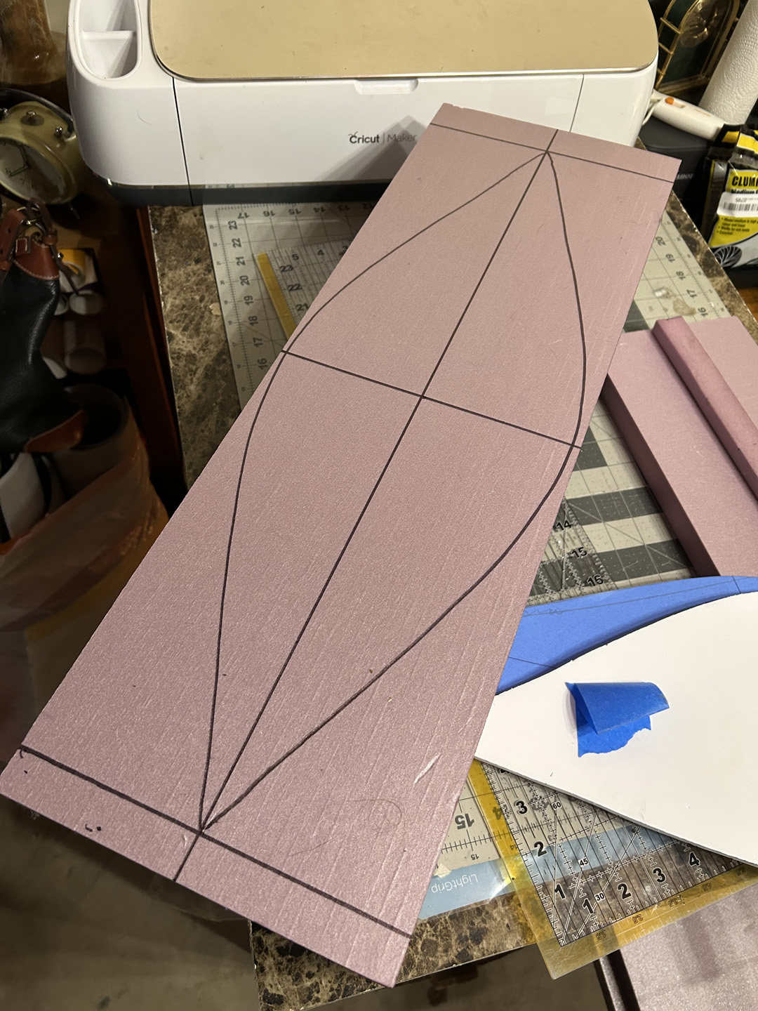 cutting a small decorative boat out of pink xps foam
