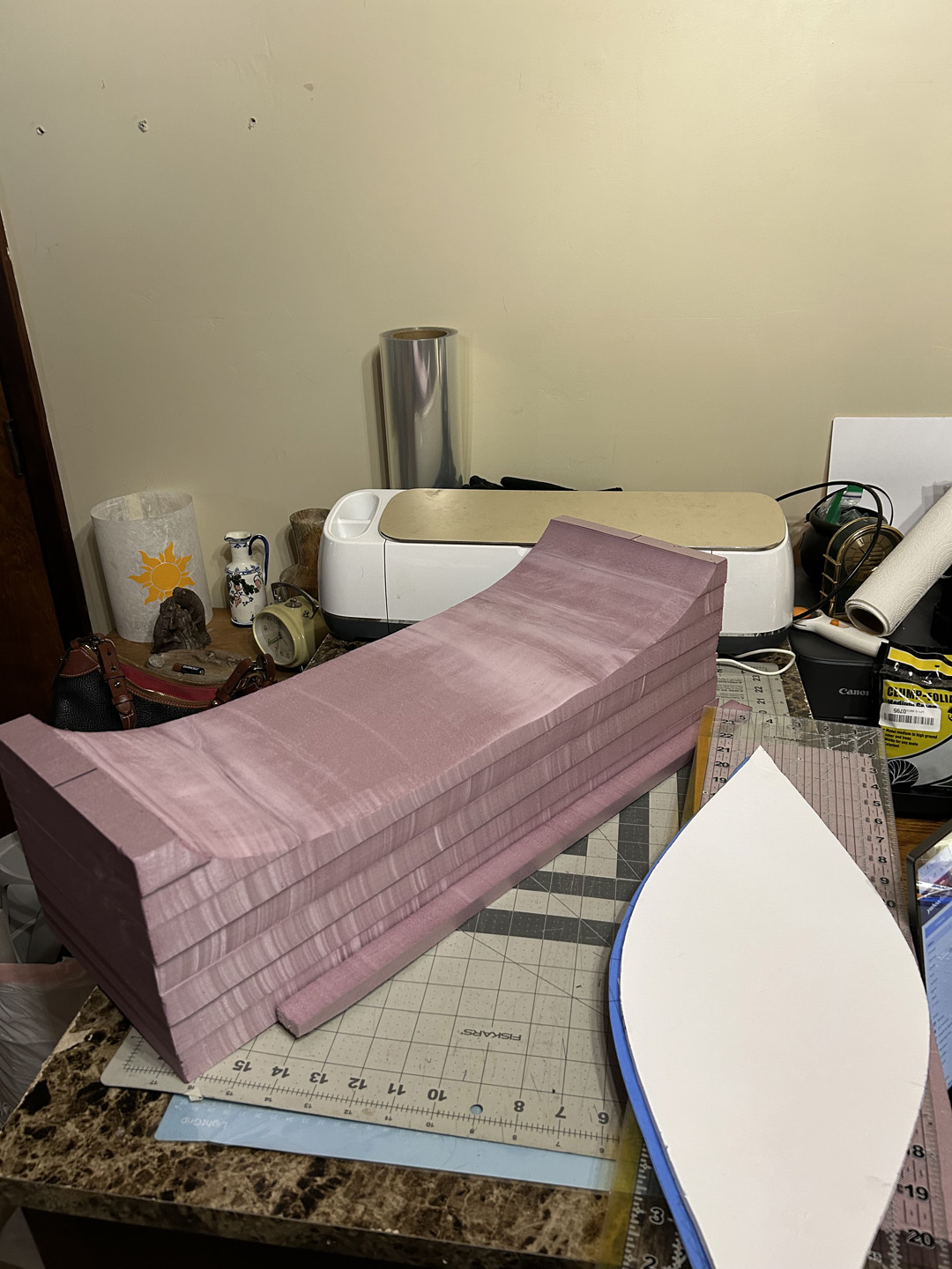 cutting a small decorative boat out of pink xps foam