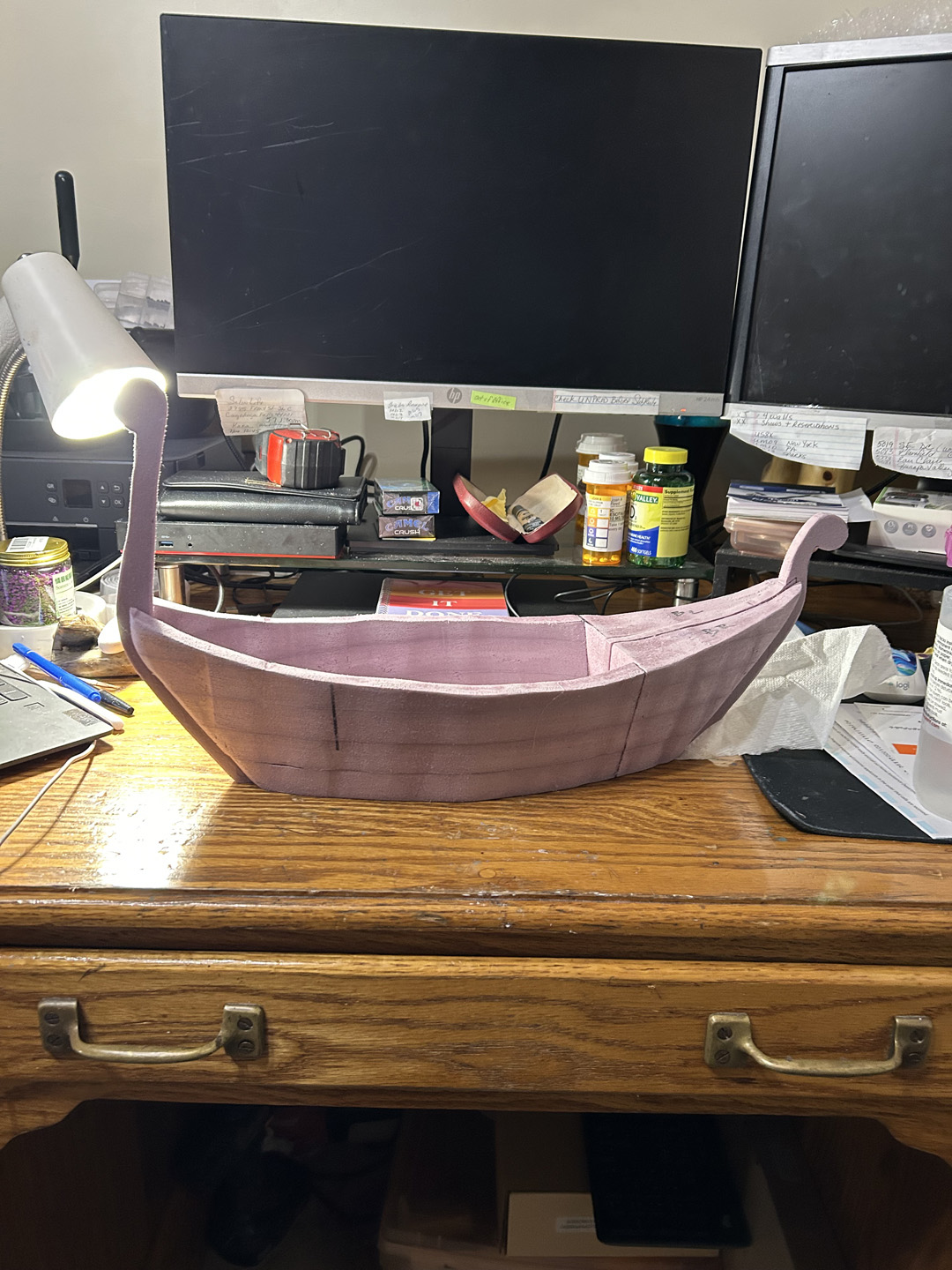 cutting a small decorative boat out of pink xps foam