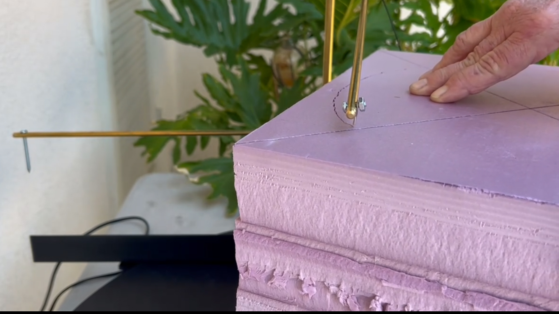 cutting a mini replica of rapunzel's tower out of pink xps foam