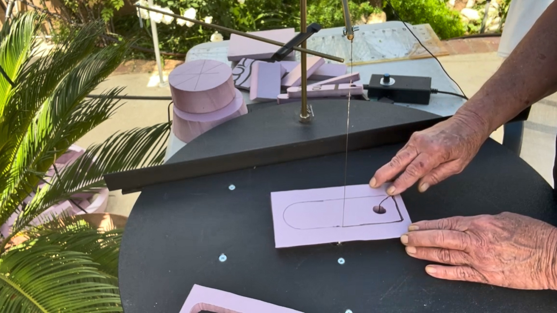 cutting out decorative pieces for a mini replica of rapunzel's tower
