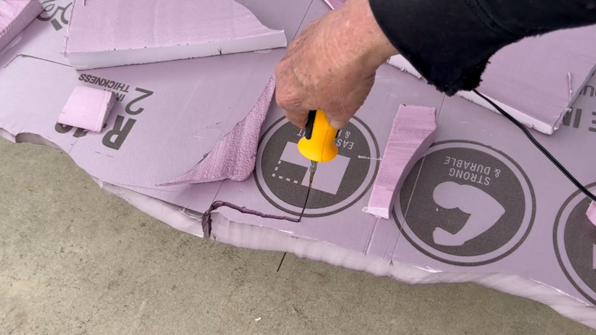cutting a faux stone backdrop out of pink xps foam