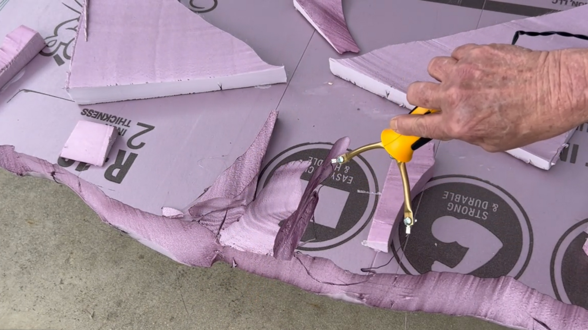 cutting a faux stone backdrop out of pink xps foam