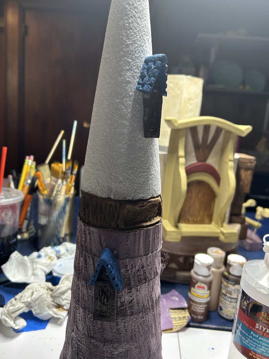 windows for a mini replica of rapunzel's tower glued to the spire