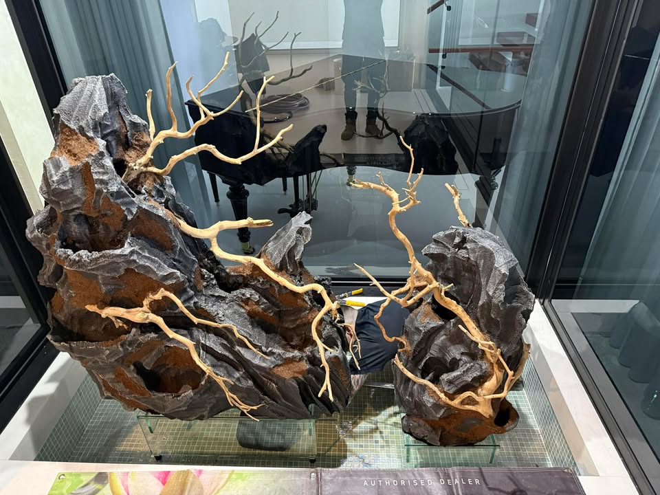 installing faux stone decorations into a pond