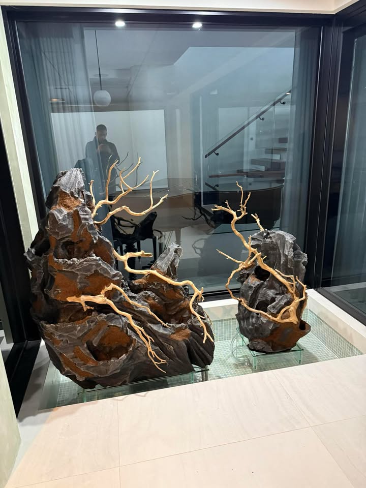 installing faux stone decorations into a pond