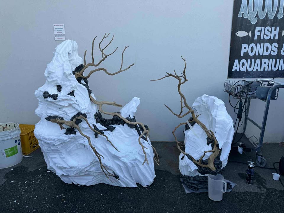 adding driftwood to fake rocks made out of eps foam