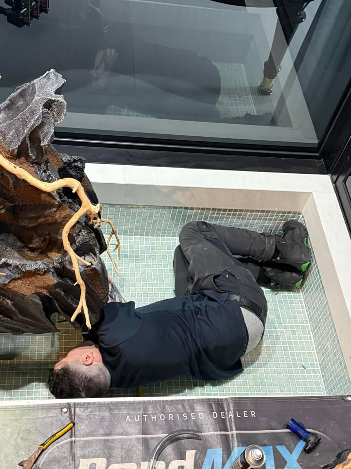 installing faux stone decorations into a pond